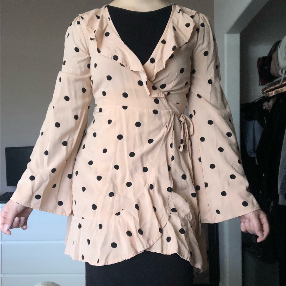 Pink wrap dress with polka dot print.